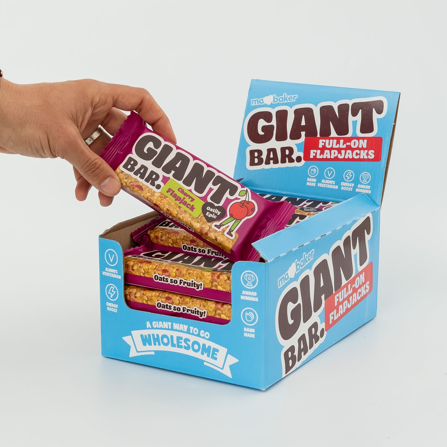 A hand taking a Cherry Giant Bar out of a box of Giant Bars