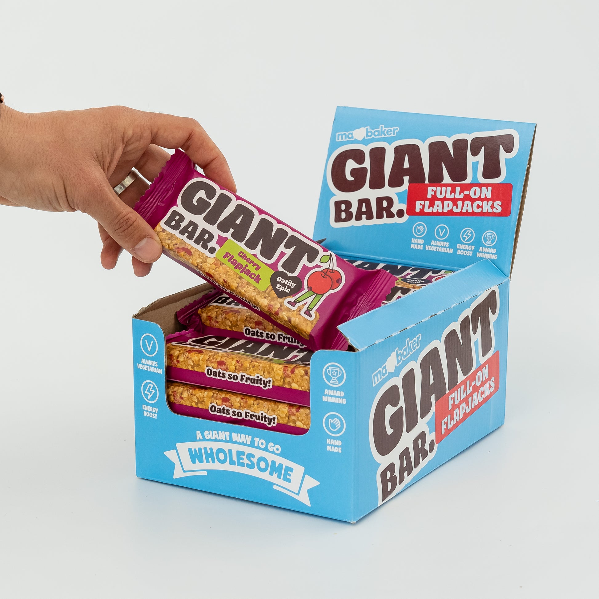 A hand taking a Cherry Giant Bar out of a box of Giant Bars