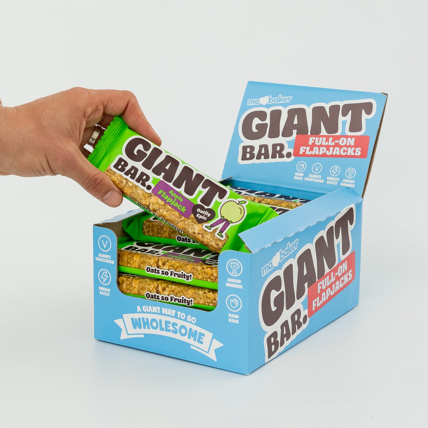 A hand taking an Apple Giant Bar from a box of Giant Bars.