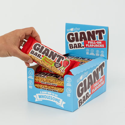 A hand taking a Strawberry Giant Bar from a box of Giant Bars