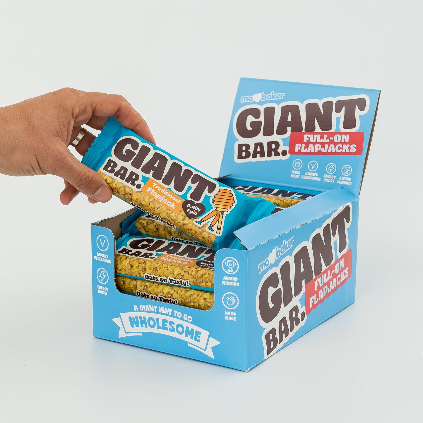 A hand taking a Traditional Giant Bar from a box of Giant Bars