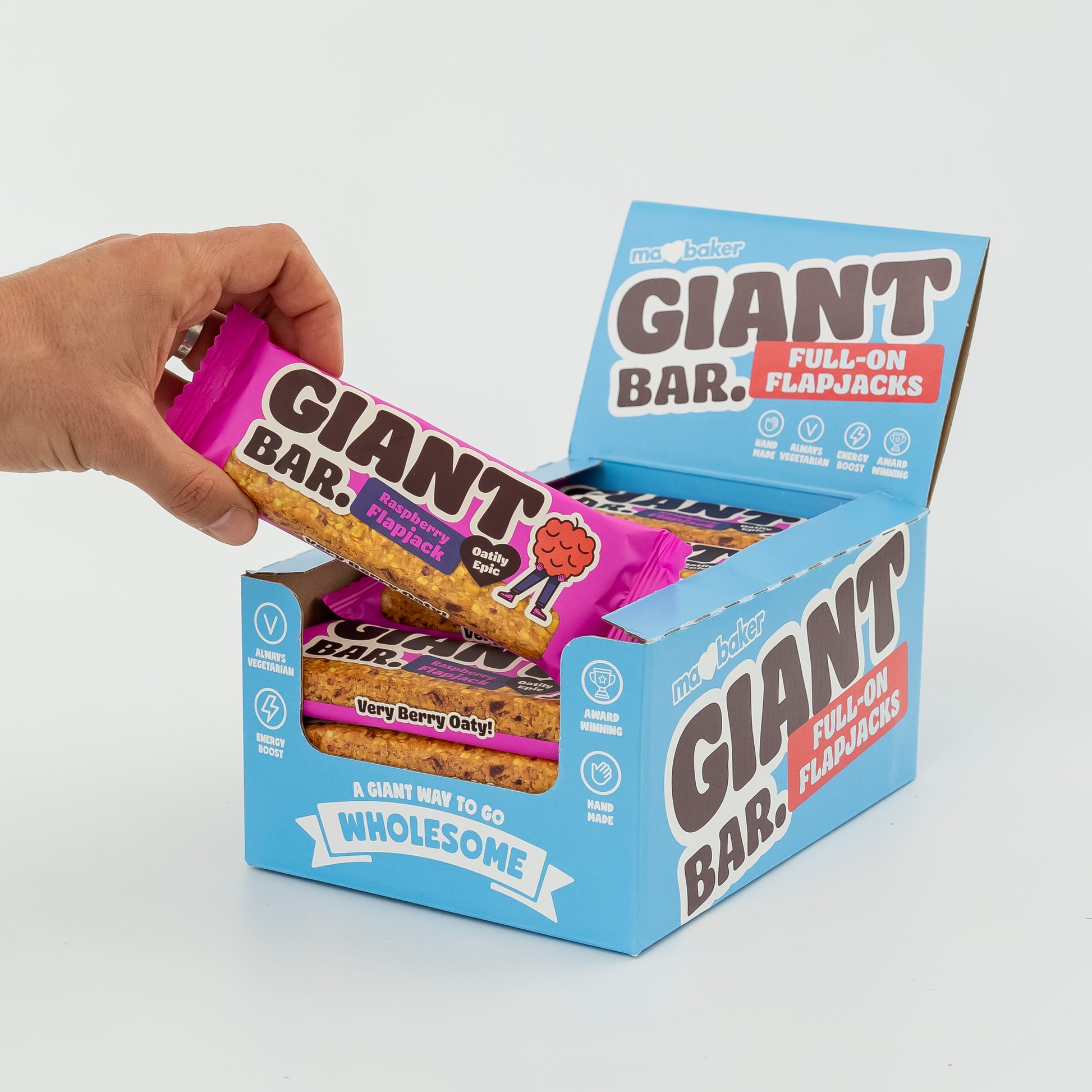 A hand taking a Raspberry Giant Bar from a box of Giant Bars