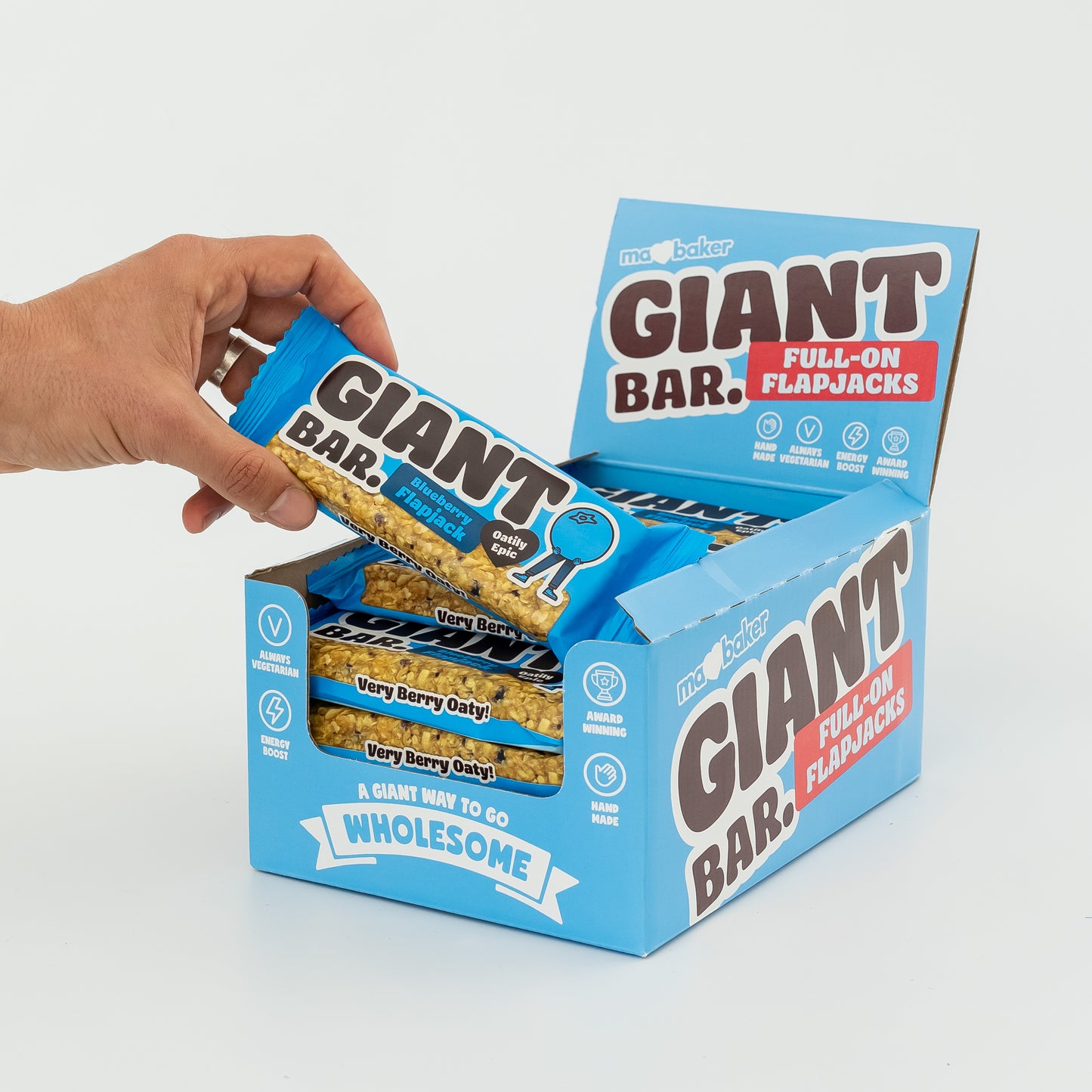 A hand taking a Blueberry Giant Bar out of a box of Giant Bars